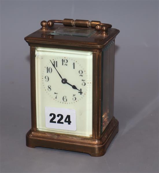 A brass carriage timepiece with enamel dial